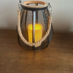 Metal and wood lantern with candle